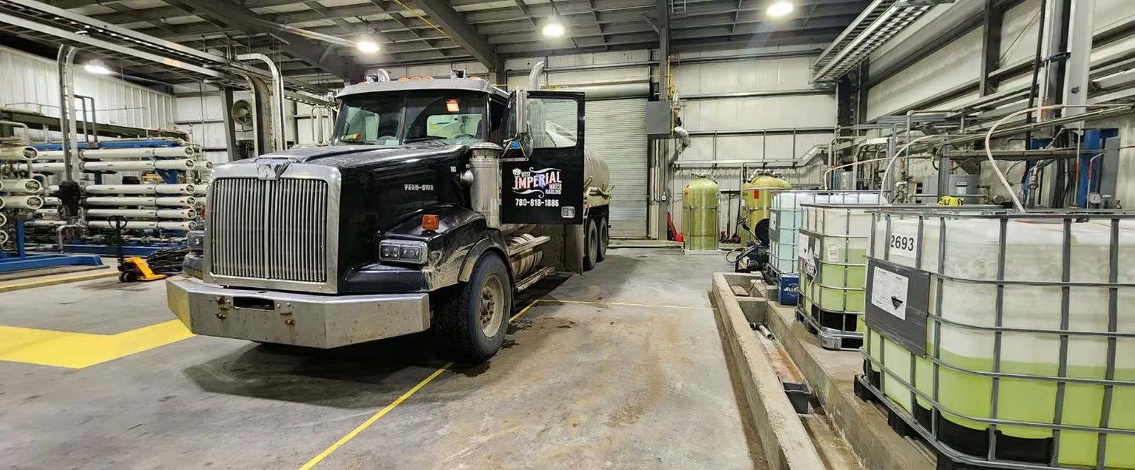 West Imperial water trucks and storage totes inside the Parkland County shop