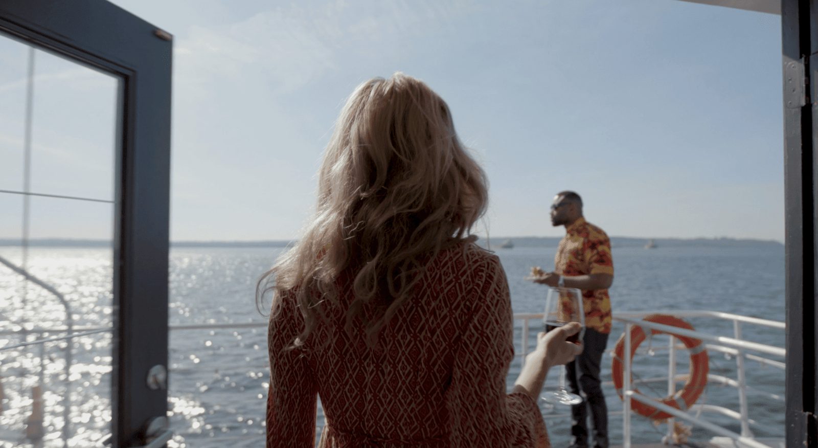 A woman on the deck of a boat looking out over the water