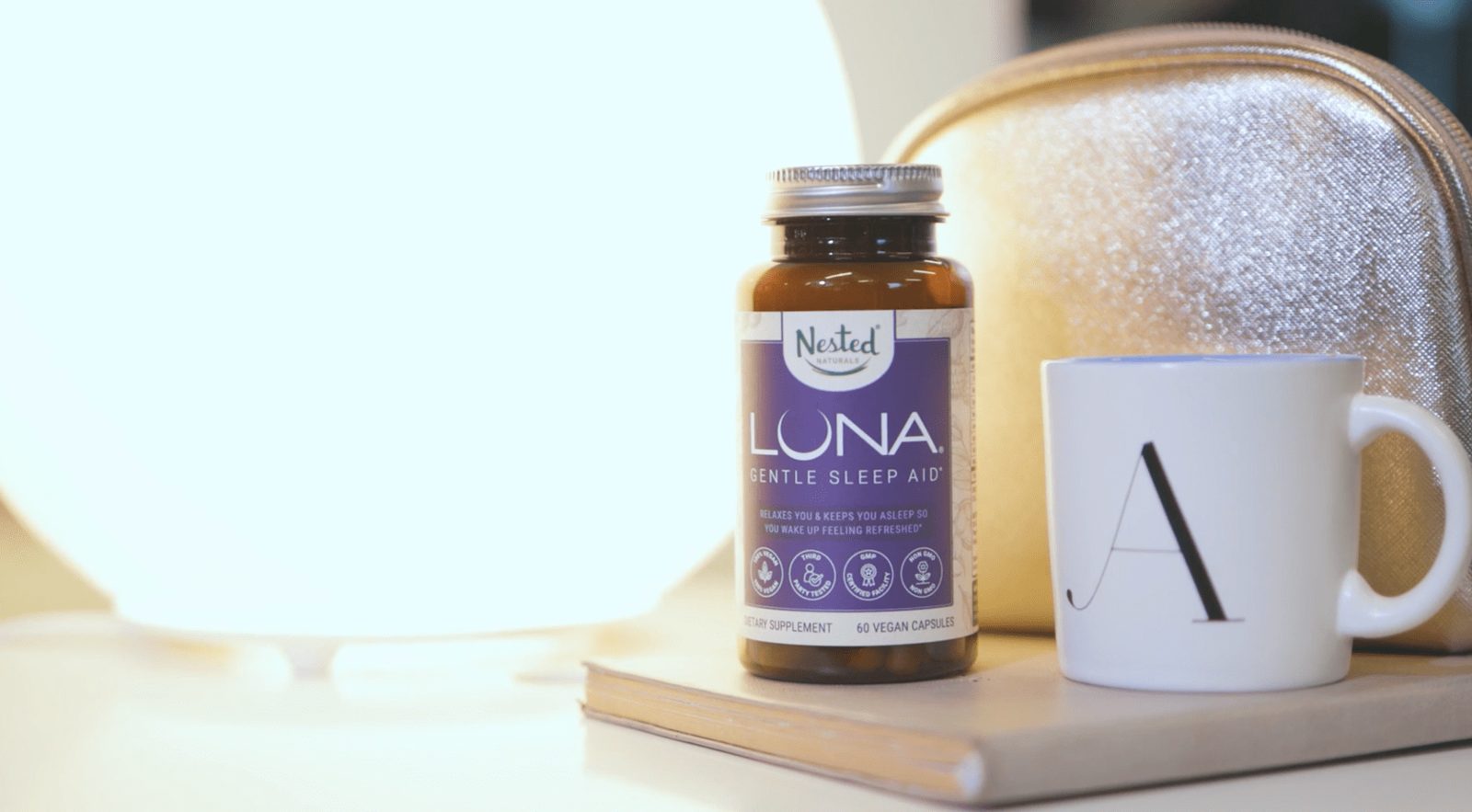 A Nested Naturals Luna bottle beside a mug, from the Nested Naturals product videos