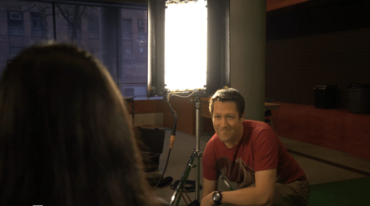 David Lavallee on set beside a studio light